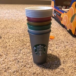 Five plastic Starbucks to go cups